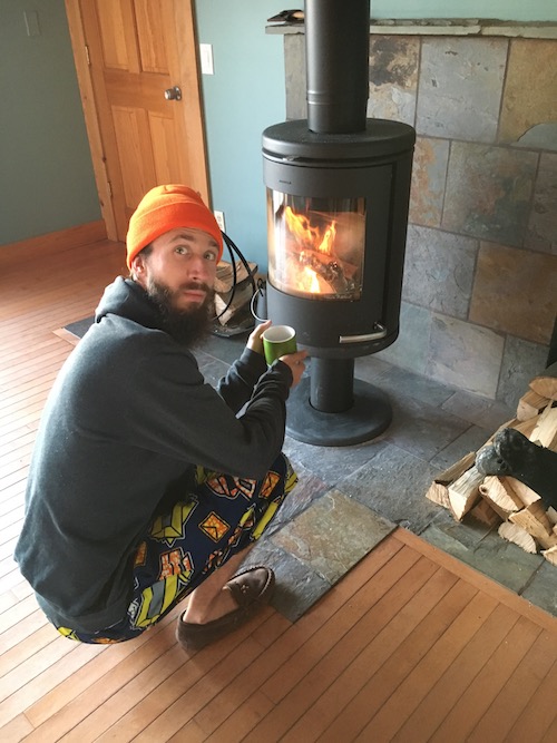 a photo of me with coffee by a wood fire